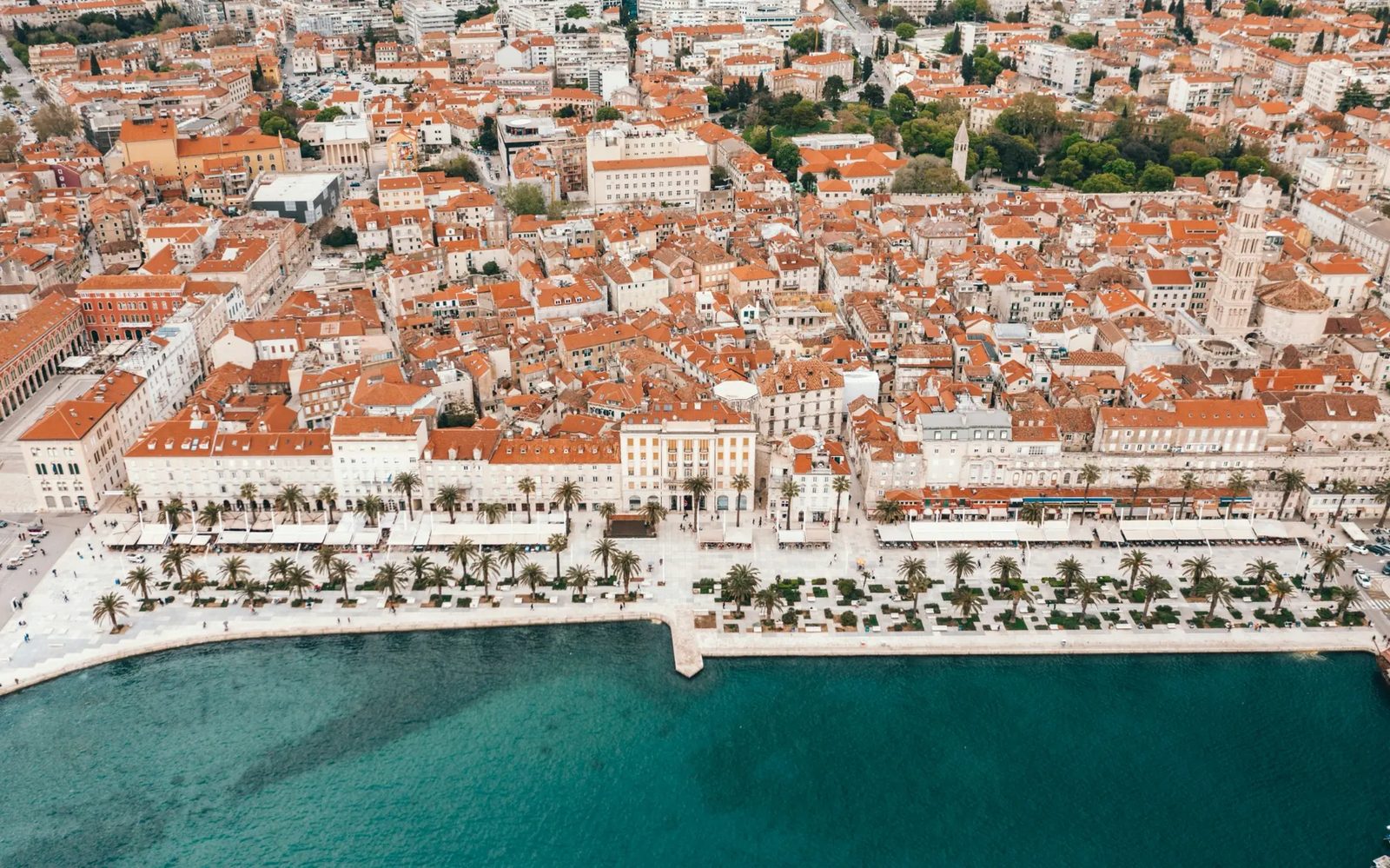 Split aerial view — compact, walkable city